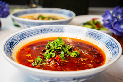 Fiery Sichuan Water-Boiled Beef (Shui Zhu Niu Rou) or Fish, loaded with chili and peppercorns, at Mo Jasmine Zurich.
