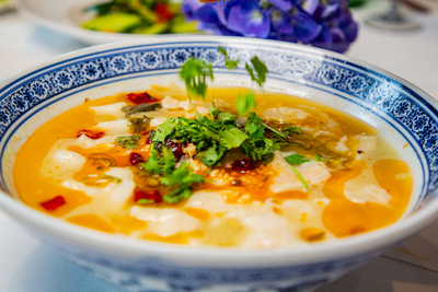 Authentic Suan Cai Yu (Sour Cabbage Fish), a comforting and tangy soup dish from Mo Jasmine Chinese restaurant in Zurich.