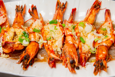 Steamed King Prawns with garlic and vermicelli noodles, a delicate seafood specialty from Mo Jasmine Chinese restaurant.