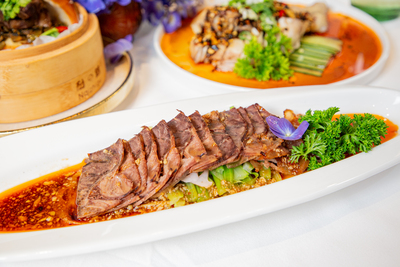 Thinly sliced spicy beef or pork belly in chili oil with garlic and herbs, a traditional Chinese cold dish from Mo Jasmine.