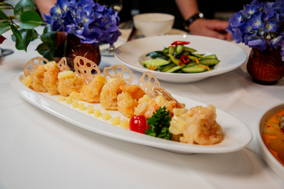 Sweet and sour crispy prawns or chicken with pineapple and lotus root chips, a delightful dish from Mo Jasmine Zurich.